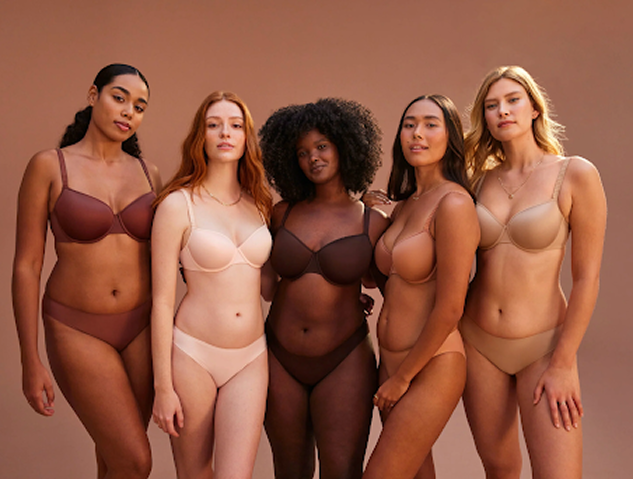 Group of models wearing shapewear in different colors