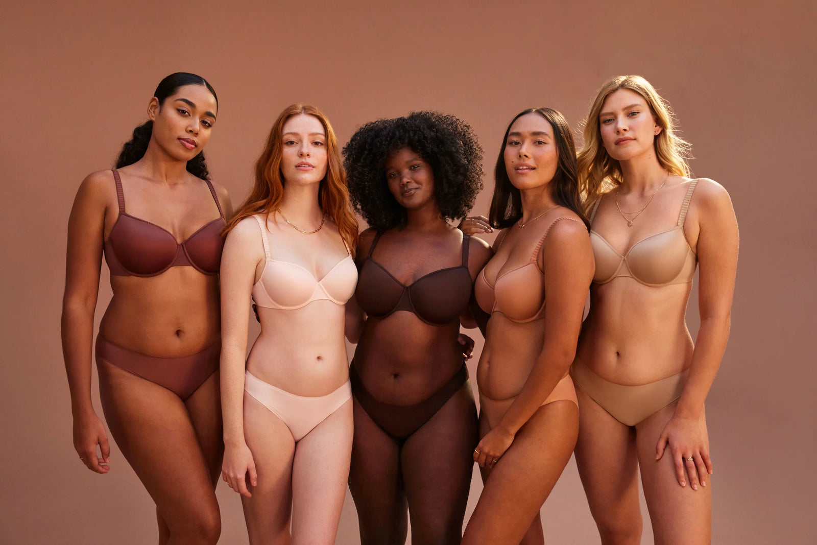 Group of models wearing shapewear in different colors